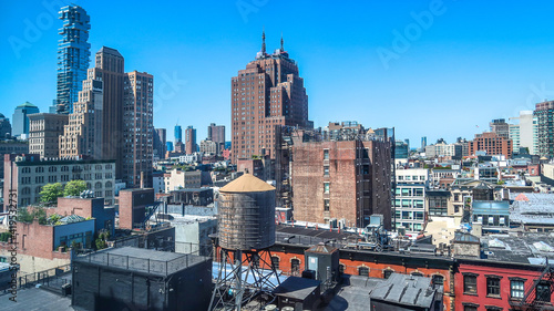 Roof view to rich city fabric of new and old, tall and low contrasting building structures and materials in New York Manhattan
