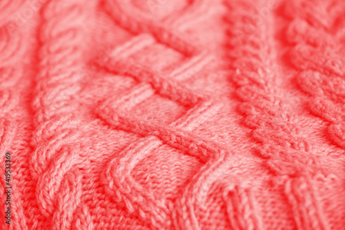 Knitting background. Craft concept. The texture of a knitted woolen fabric of a warm winter product Close-up.