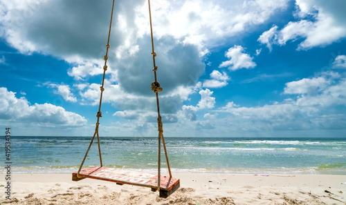 Swing attached to a palm tree in the idyllic Sao beach in Phu Quoc island, Vietnam. Sao beach is one of the best beaches of Vietnam.
