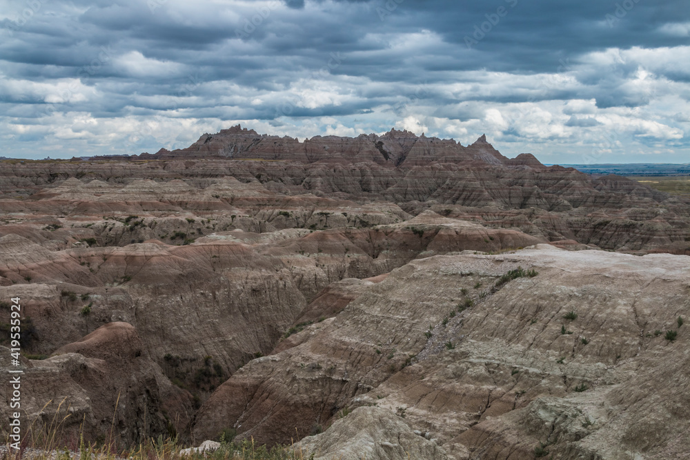 low cotton like summer clouds covering the sky in Badlands National Park in South Dakota. low cotton like summer clouds covering the sky in Badlands National Park in South Dakota.