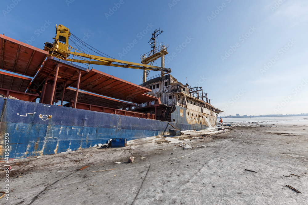 Environmental disaster at sea. A commercial small ship carrying oil sinks in ice within the city limits. The stern of the ship goes under water. Environmental disaster at sea. A commercial small ship carrying oil sinks in ice within the city limits. The stern of the ship goes under water.