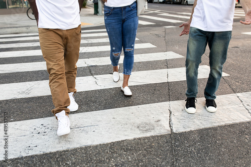 Streetwear apparel jeans men and women crossing road in city