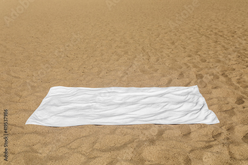 Valokuva White beach towel on the sand
