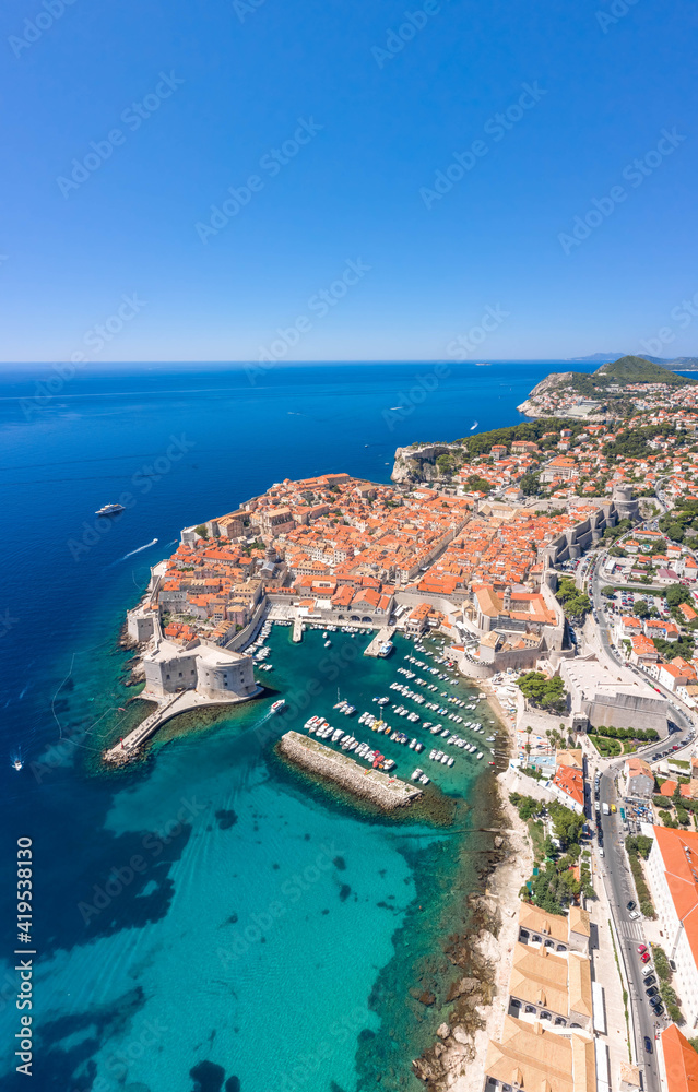 Aerial drone shot of Old Port in east Dubrovnik old town in Croatia summer noon