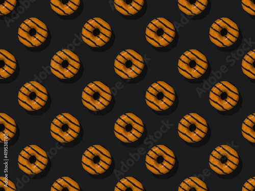 A pattern of orange donuts on a black background.