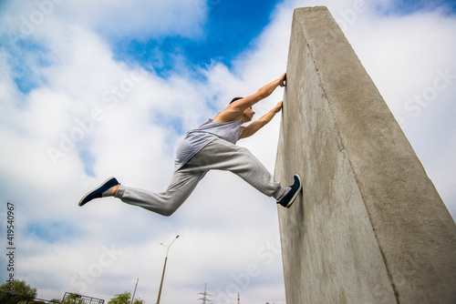 Man engaged in parkour jumping on the street 