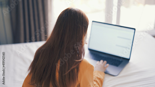 woman at laptop or already in bed rest internet work