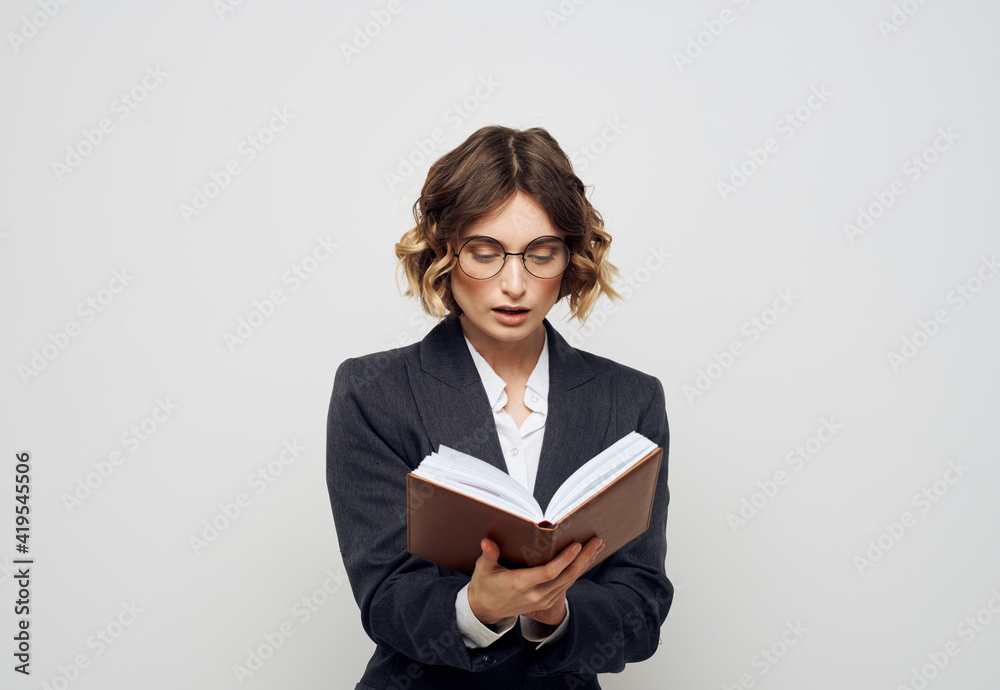 Woman in classic suit with open book glasses on face cropped view Woman in classic suit with open book glasses on face cropped view