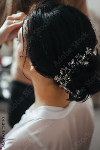 Wedding hairstyle. Tiara with diamonds. Hairdresser.