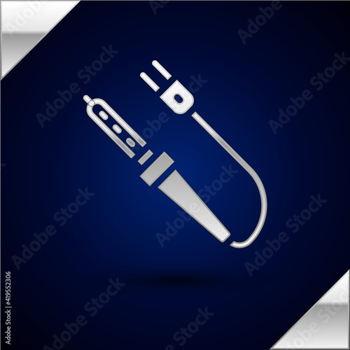 Silver Soldering iron icon isolated on dark blue background. Vector.
