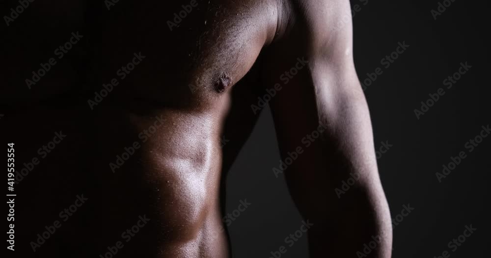 Shirtless muscular man over black background Shirtless muscular man over black background