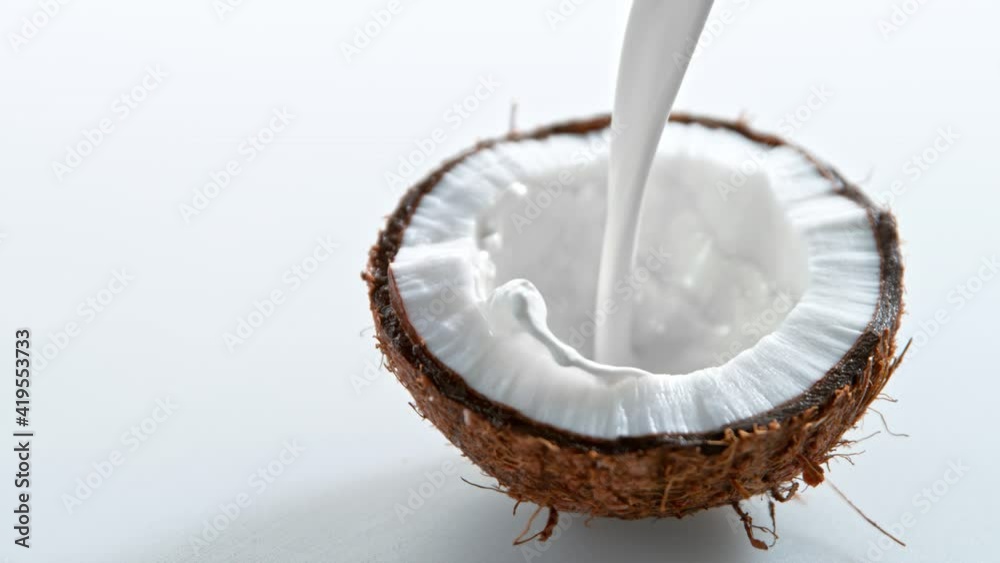 Super Slow Motion Shot of Milk Splashing on Fresh Coconut at 1000fps.