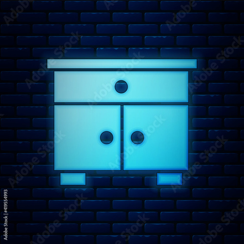 Glowing neon Furniture nightstand icon isolated on brick wall background. Vector.