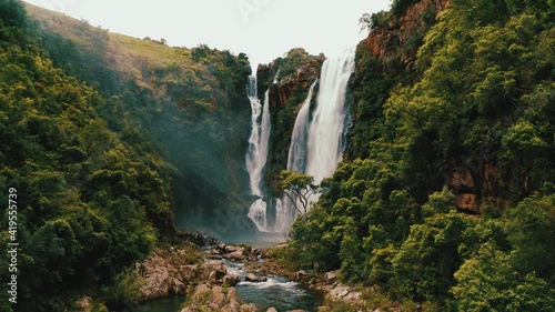Beautiful waterfall in green forest, top view. Tropical in mountain jungle. Waterfall in the tropical forest. Big Waterfall in 4k