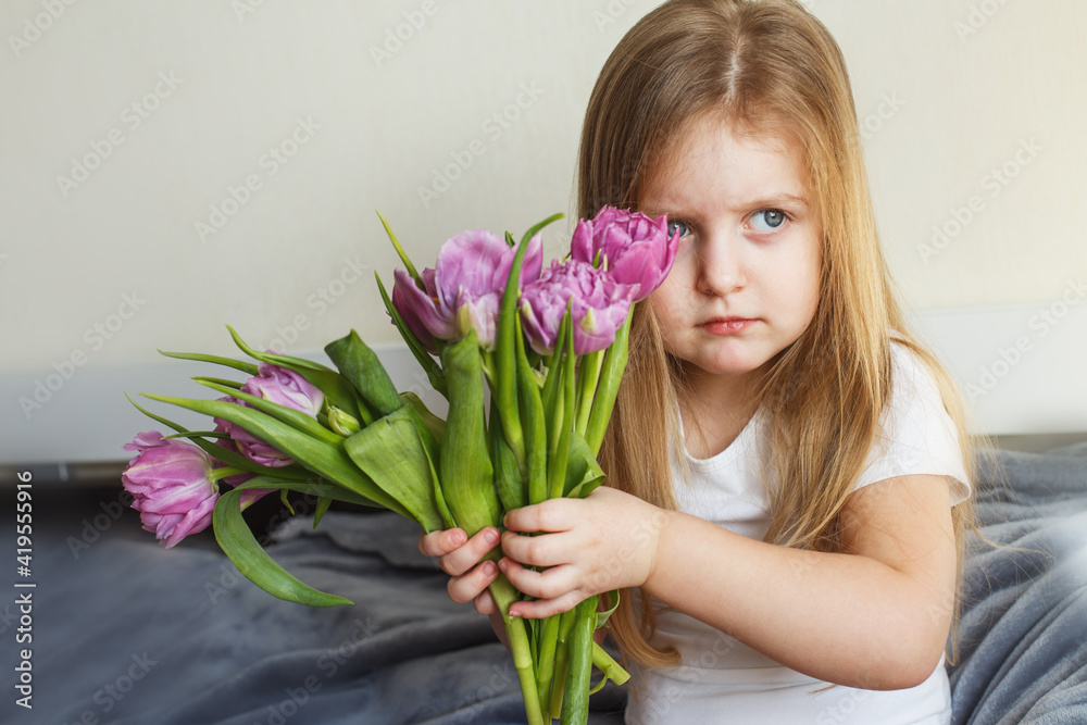 portrait of litlle girl with bouquet of flowers tulips in her hands portrait of litlle girl with bouquet of flowers tulips in her hands