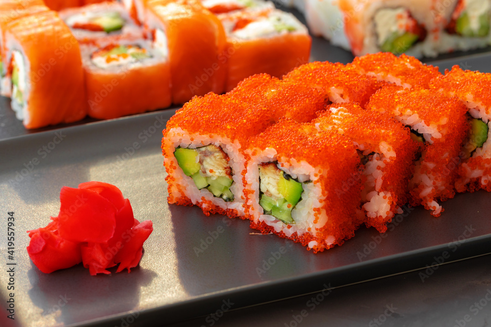 Set of various sushi rolls served on gray background Set of various sushi rolls served on gray background