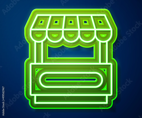 Glowing neon line Fast street food cart with awning icon isolated on blue background. Urban kiosk. Vector.