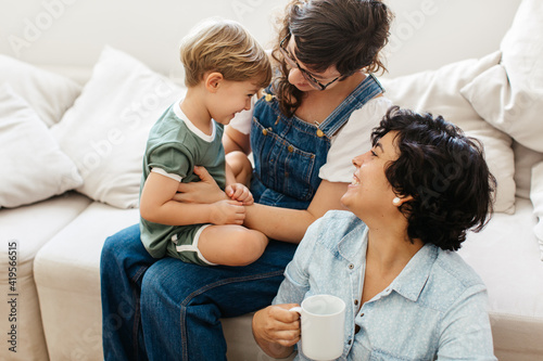 Fototapeta Loving lesbian couple spending time with her son at home