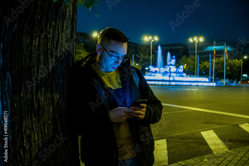 Young person night photography in Madrid Street with lights and buildings