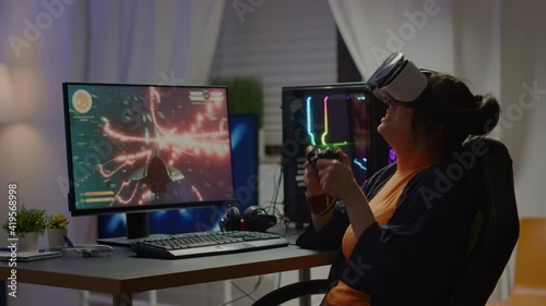 Sad woman gamer wearing virtual reality headset losing space shooter games on online tournement using wireless controller. Defeated player playing for online competition late night in gaming room photo