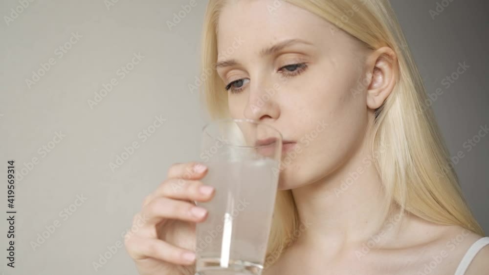 Beautiful young woman taking medicine. Taking pills for headaches and fever Beautiful young woman taking medicine. Taking pills for headaches and fever