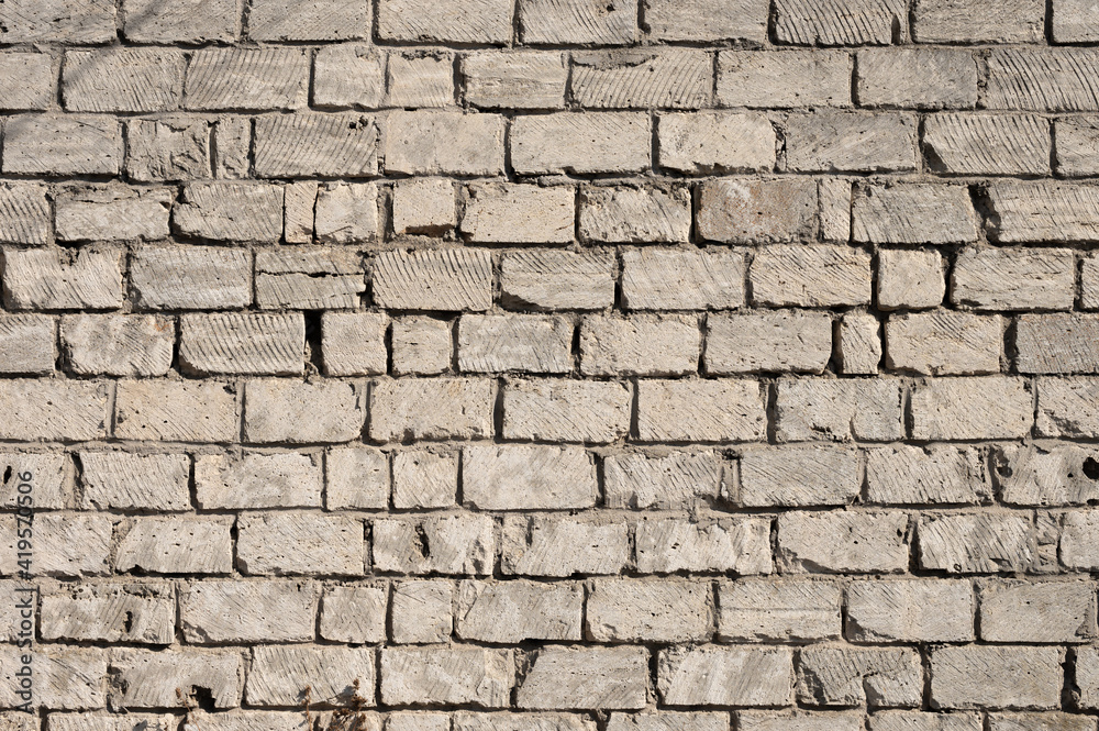 Wall pattern dirty cement assorted bricks. Cement-stained wall from broken bricks Wall pattern dirty cement assorted bricks. Cement-stained wall from broken bricks