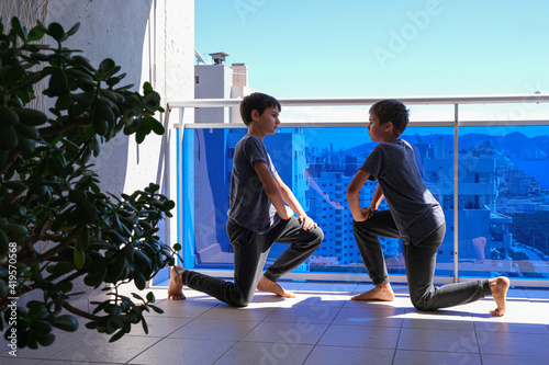 Boys doing sport exercises on balcony. Sport, healhty lifestyle, active leisure at home