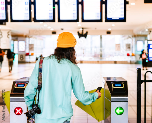 Picture from the back of a young male who enters to the train station in Australia