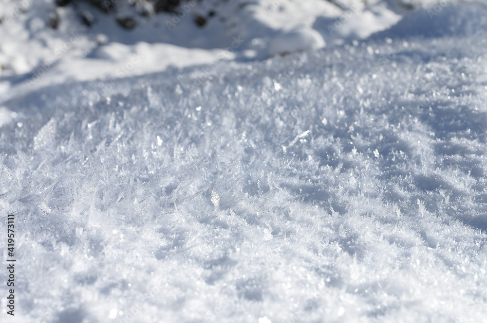 Large crystals on the snow surface on a sunny winter day. Winter background