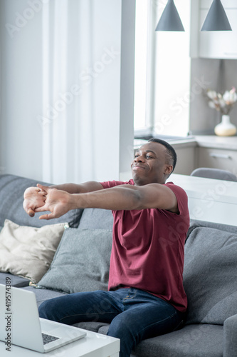 African american young man looking sleepy and stretching