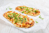 Tarte Flambee - flat bread (Flammkuchen) with bacon, onion, champignon and cheese