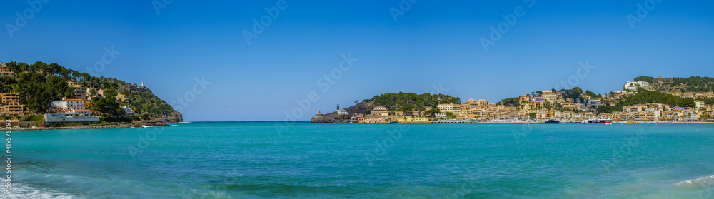 beach with trees and buildings  in the village of Port de Soller on  the balearic island of Mallorca, spain