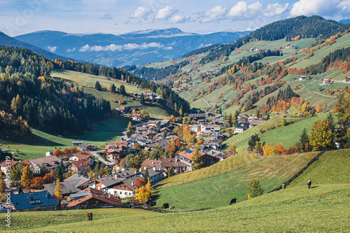 Landscape of early autumn in the village of Santa Magdalena in northern Italy on the slopes of the Dolomites in the valley of Val di Funes.