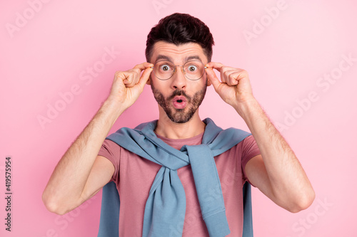 Photo of charming amazed young man wear glasses amazed news information isolated on pink color background