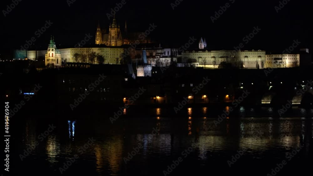 motion view of Prague Castle and St. Vitus Cathedral and Charles Bridge on the Vltava River in the center of Prague at night motion view of Prague Castle and St. Vitus Cathedral and Charles Bridge on the Vltava River in the center of Prague at night