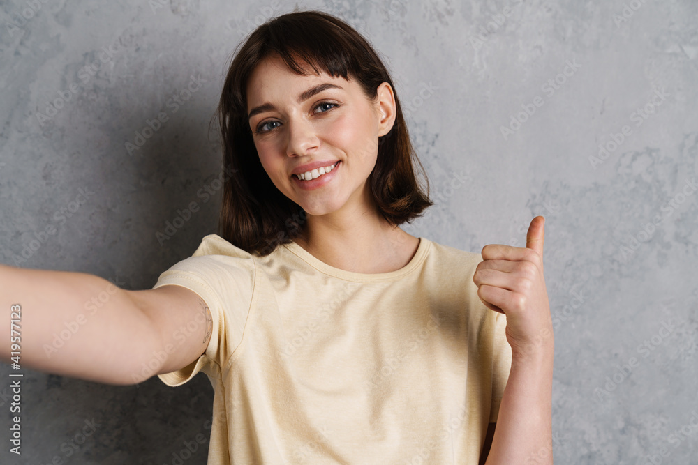 Smiling young girl taking a selfie photo on smartphone Smiling young girl taking a selfie photo on smartphone
