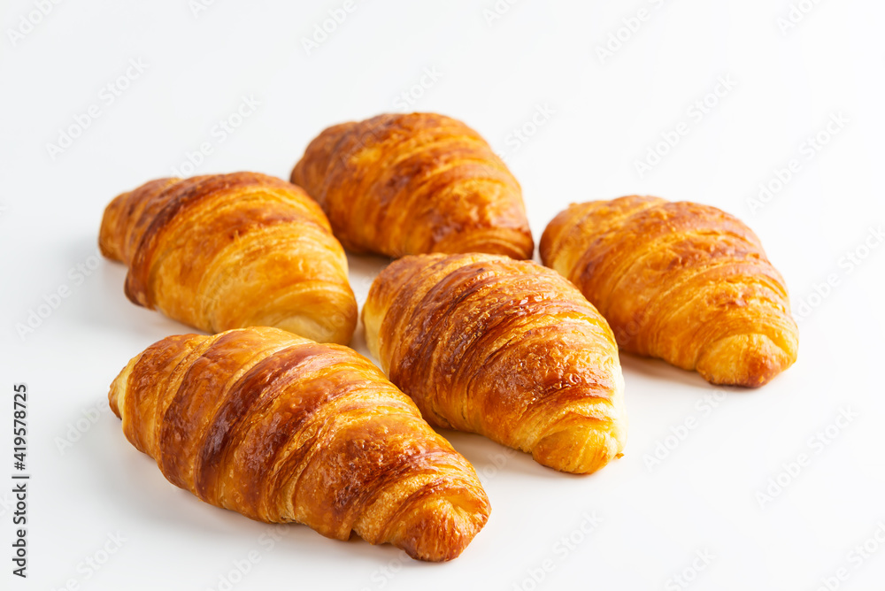 Fresh French croissants on a white background. Fresh French croissants on a white background.