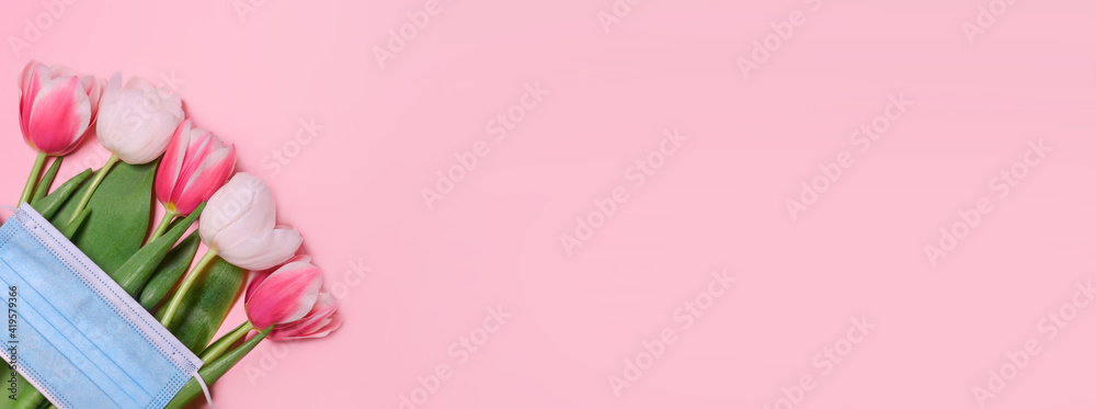 Tulips, medical mask on a pink background.Spring background, Mother's Day, Women's Day, Spring day, Easter background. Copy space.Safe celebration in perdio of the coronavirus outbreak.Banner Tulips, medical mask on a pink background.Spring background, Mother's Day, Women's Day, Spring day, Easter background. Copy space.Safe celebration in perdio of the coronavirus outbreak.Banner