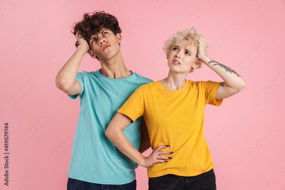 Portrait of a pensive teenage couple standing isolated Portrait of a pensive teenage couple standing isolated