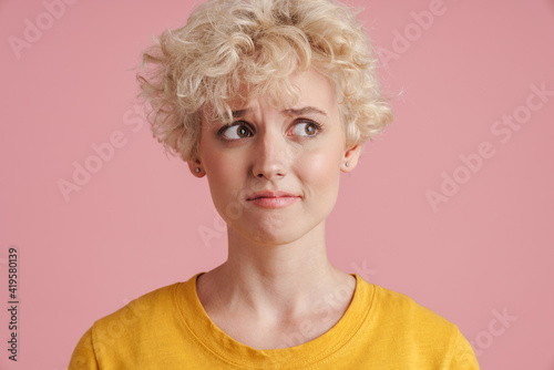 Portrait of a young blonde girl with curly blonde hair