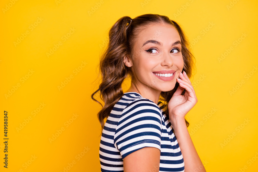 Photo of funny shiny young lady dressed striped outfit arm cheek looking back empty space isolated yellow color background Photo of funny shiny young lady dressed striped outfit arm cheek looking back empty space isolated yellow color background