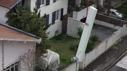 5G antenna being lifted by a crane to be installed on top of a building