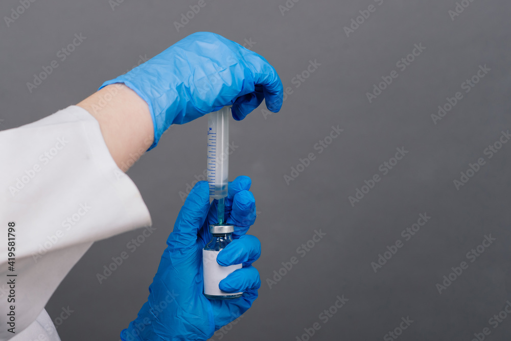 Doctor scientist with syringe analyzing virus in research vaccine to be ready for clinical trial. Doctor scientist with syringe analyzing virus in research vaccine to be ready for clinical trial.