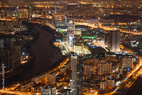 view of the big city of night with river and lighted streets and buildings  © Vitaliy Honor 