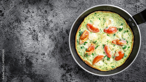 Frittata Omelet with vegetables and cheese in a frying pan. Ketogenic, keto food. banner, menu recipe top view