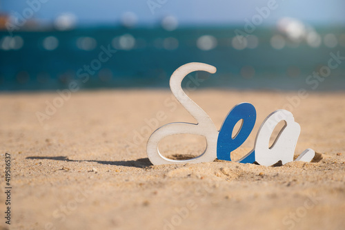 Decorative Sea inscription  woodenl letters on the beach in the sand