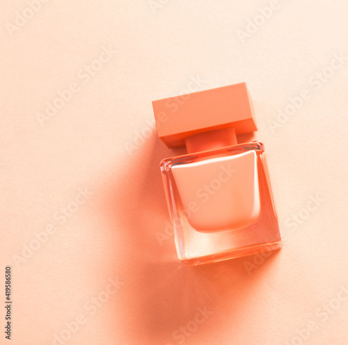 orange perfume bottle on orange background