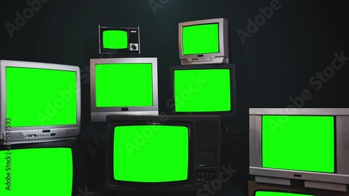 group of vintage wood plastic and chrome television that are displaying a green screen