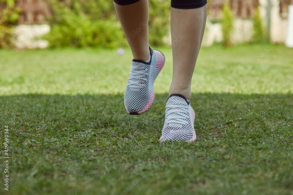 A young woman stretching and getting ready for running. Healthy lifestyle. Sport outdoor.