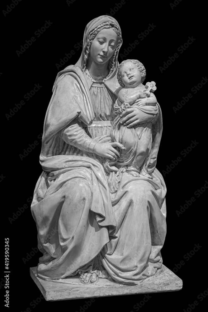 Statue of the virgin Mary carrying the baby Jesus isolated on black background. Mother of god sculpture, classic christian art